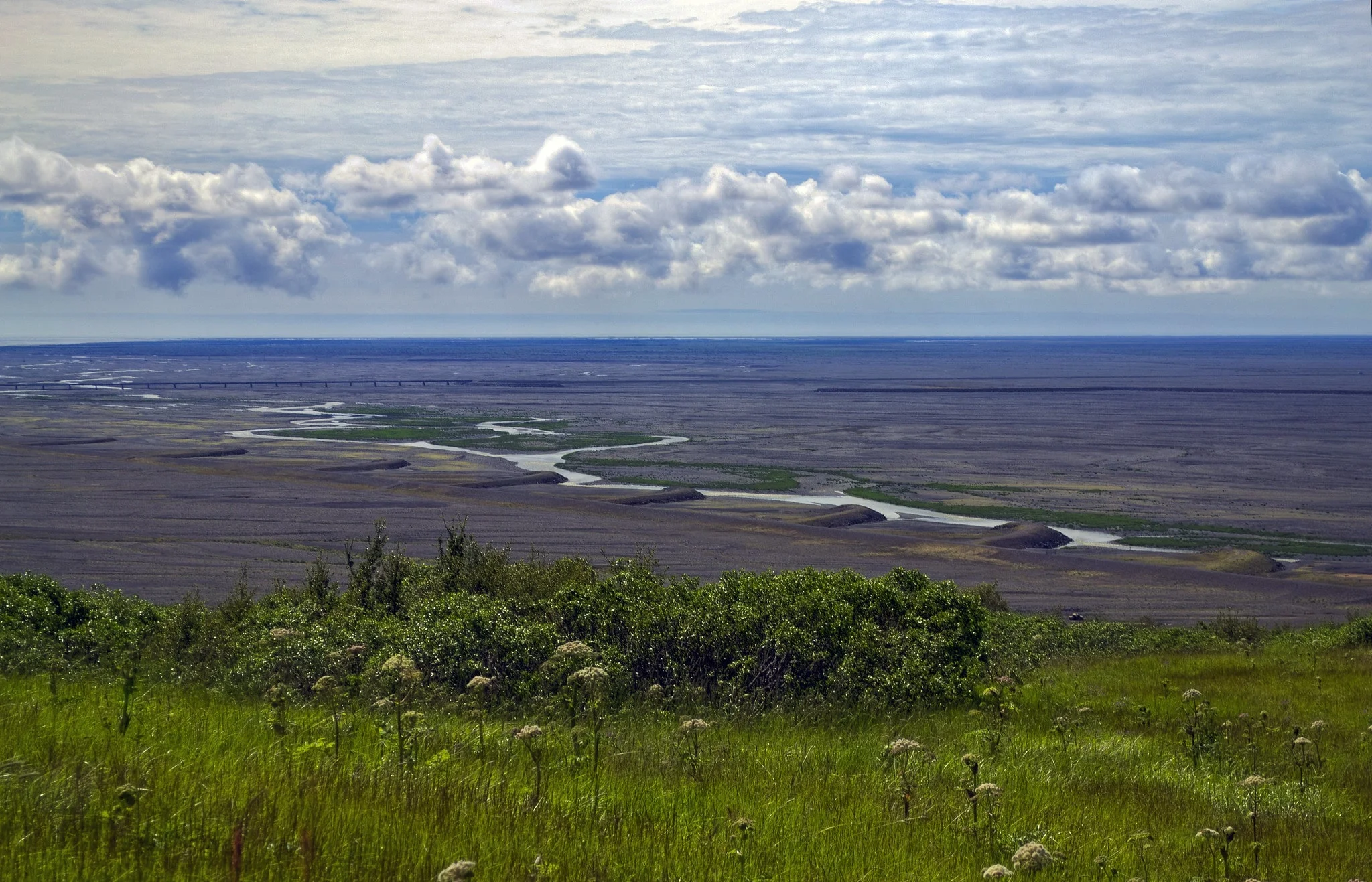 A view of Skeidárarsandur with dikes and a long bridge by photographer Gudrun