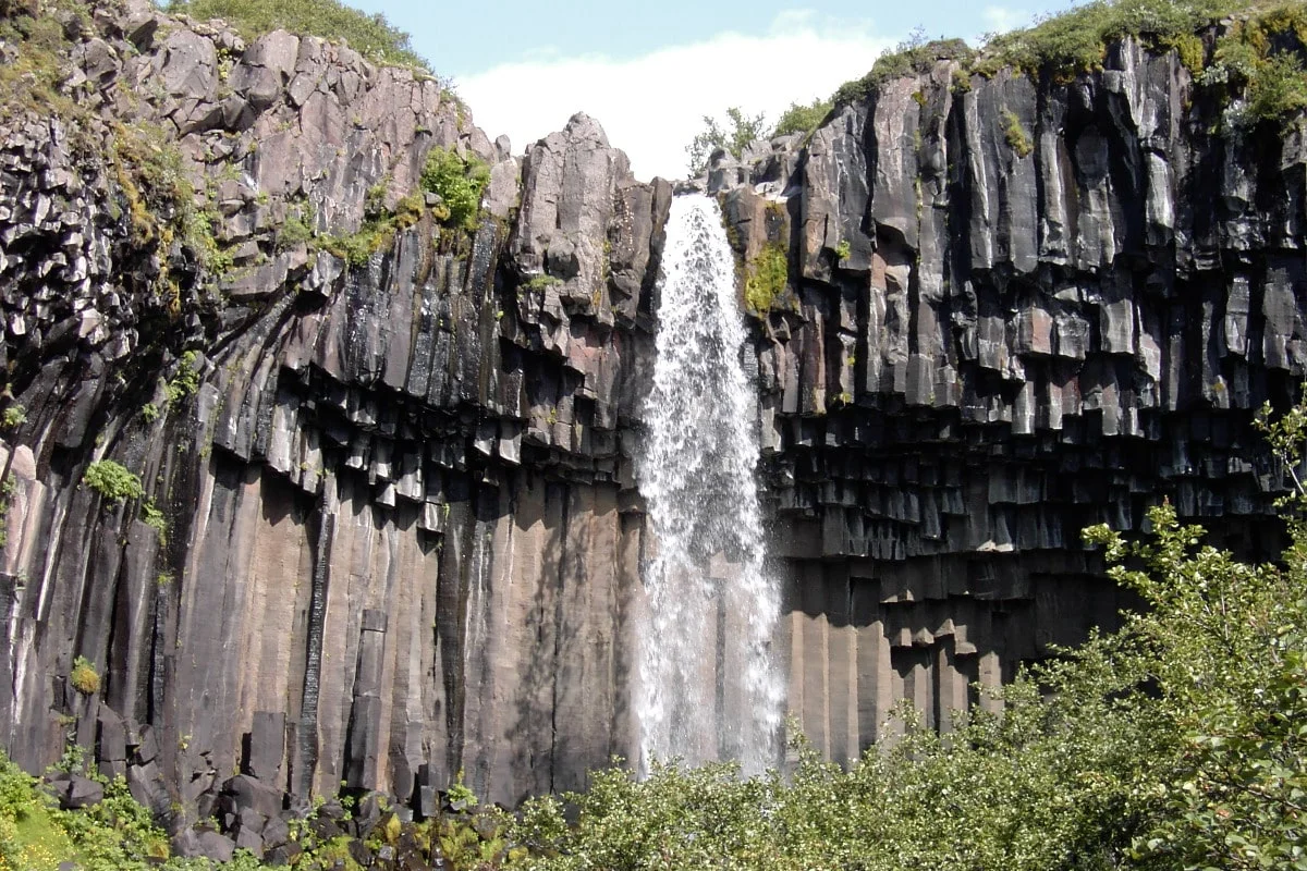 Svartifoss framed in basalt rock by photographer Cris